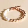 Adorne Half Pearl Metal Ball Toggle Bracelet | Gold/Cream